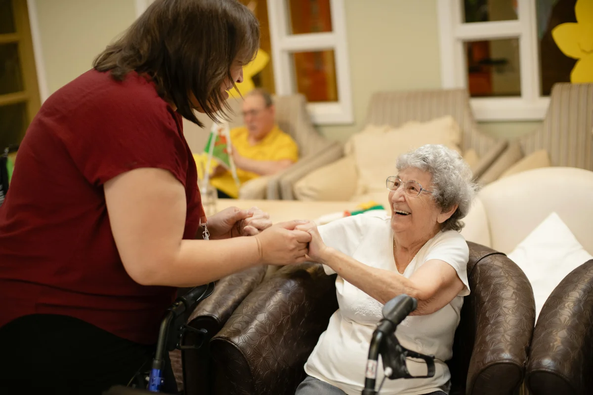 Caregiver holding hands with senior patient