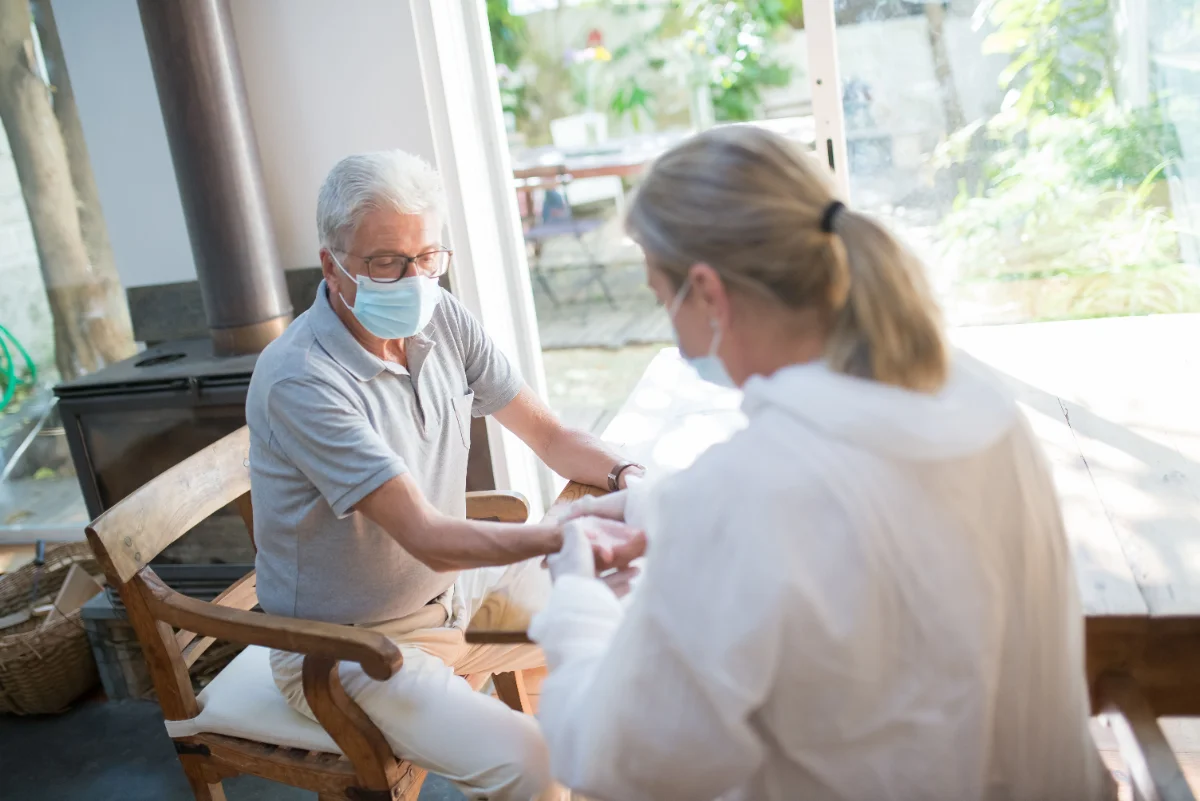 CNA dressing a wound with bandages